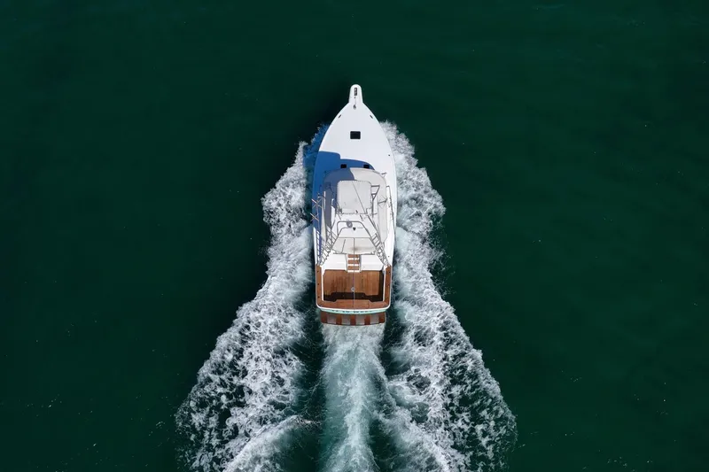 Slide: The Image of Aerial view of 1997 Strike 42 Express yacht cruising on open water. - 9