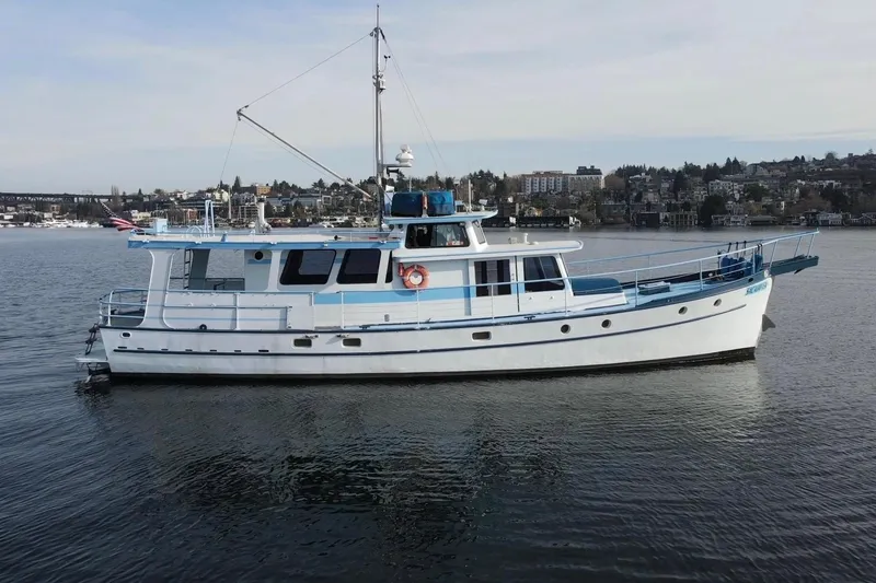 The Image of Vintage 1965 Custom Trawler on calm water with cityscape background. - 0