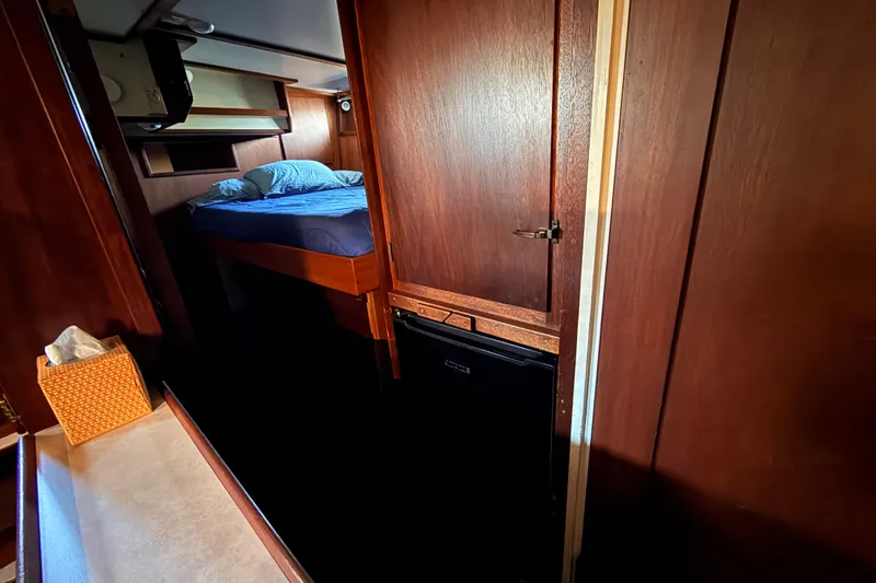 Slide: The Image of Cozy cabin interior of a 1965 custom trawler with wooden paneling and a bed. - 15