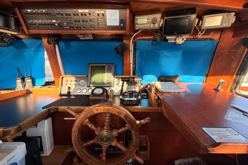 Slide: The Image of 1965 Custom Trawler helm with navigation equipment and wooden steering wheel. - 29