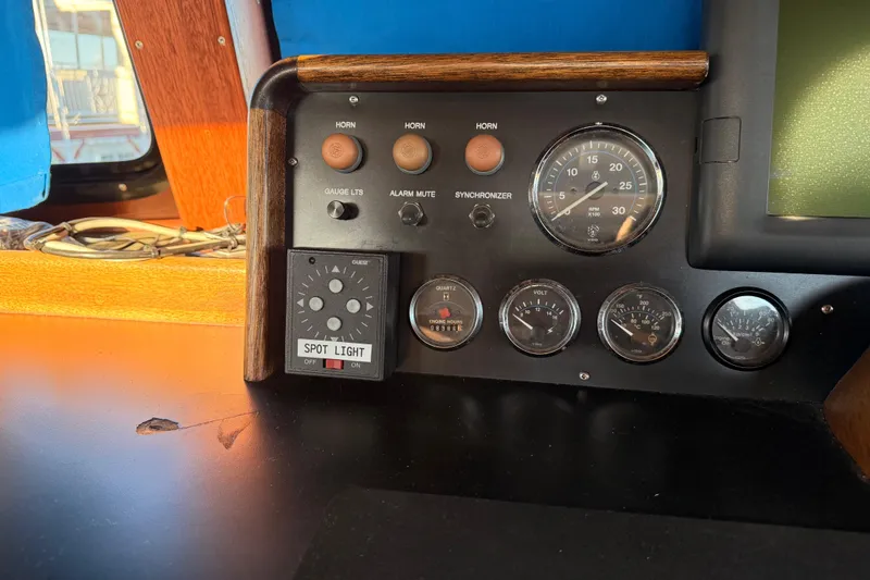 Slide: The Image of Control panel of a 1965 Custom Trawler with gauges and spotlight switch. - 32