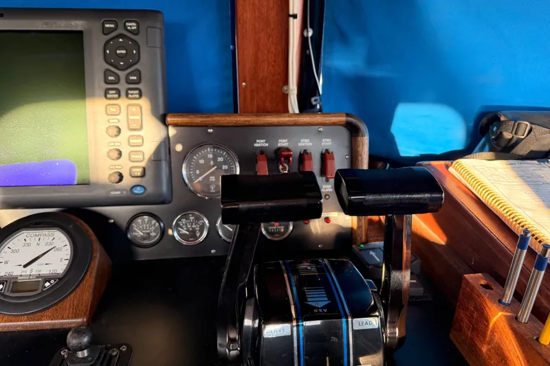 Slide: The Image of Control panel of a 1965 Custom Trawler with navigation instruments and throttle levers. - 33