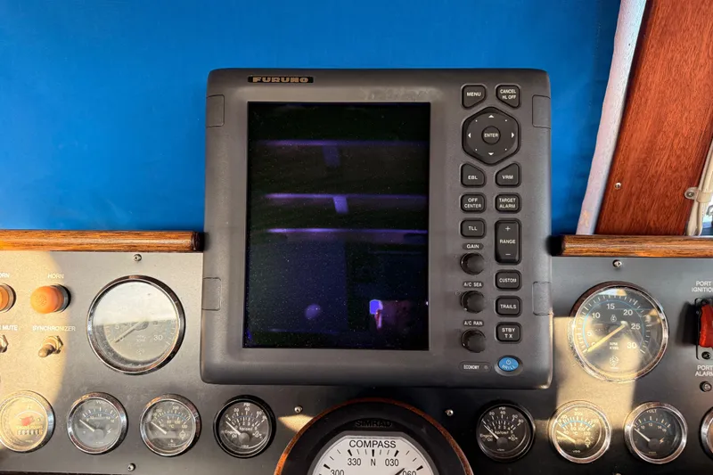 Slide: The Image of Control panel of a 1965 Custom Trawler with navigation instruments and gauges. - 35