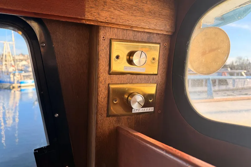 Slide: The Image of Vintage 1965 custom trawler interior with brass control knobs near window. - 36