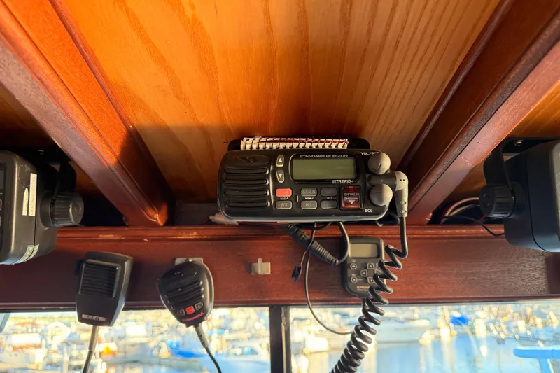 Slide: The Image of 1965 Custom Trawler radio equipment with wooden interior, featuring communication devices. - 39