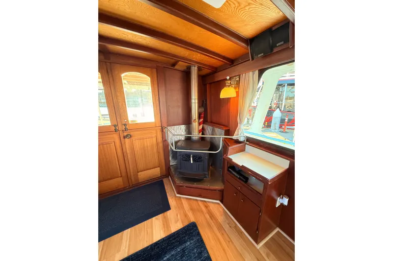 Slide: The Image of Interior of a 1965 custom trawler with wood paneling and a cozy stove. - 4