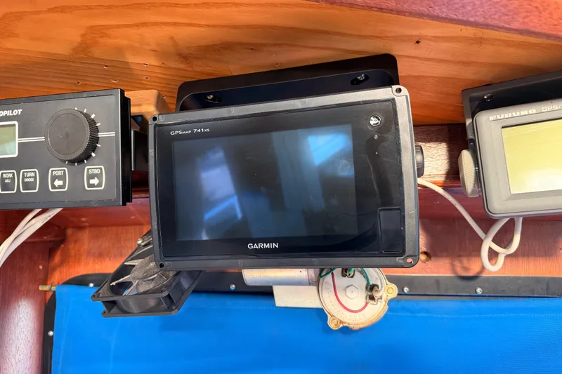 Slide: The Image of Navigation equipment on a 1965 Custom Trawler, featuring Garmin GPS and autopilot controls. - 42