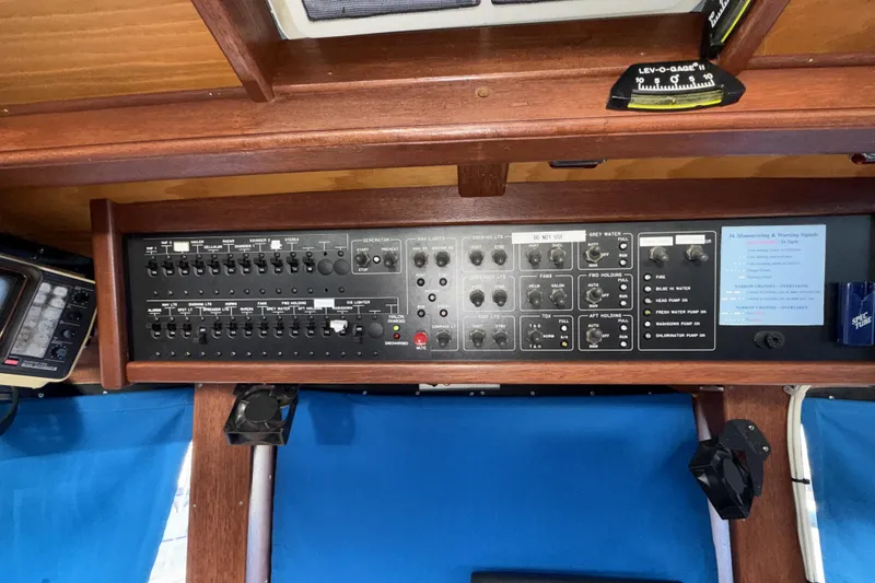 Slide: The Image of Control panel of a 1965 Custom Trawler with various switches and gauges. - 44