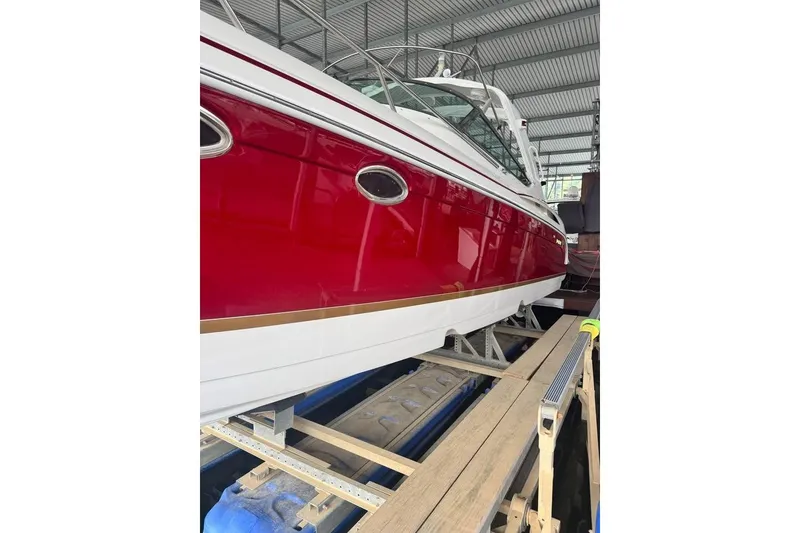 Slide: The Image of 2003 Formula 400 Super Sport boat in storage, featuring a sleek red and white design. - 2