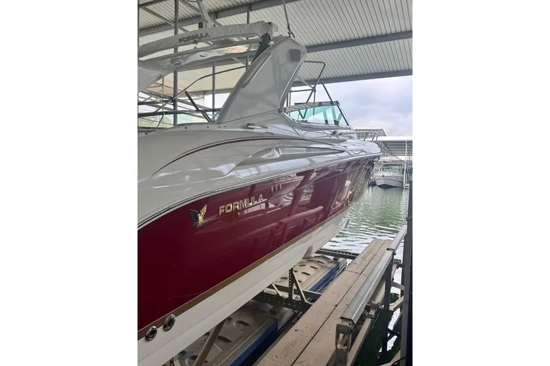 Slide: The Image of 2003 Formula 400 Super Sport boat docked in a marina, showcasing sleek design. - 4