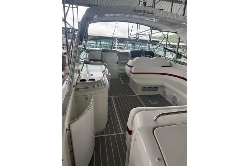 Slide: The Image of 2003 Formula 400 Super Sport boat interior with seating and helm under canopy. - 7