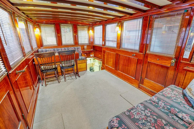 Slide: The Image of Interior of a 1926 Hacker-Craft Bridge Deck boat with wooden finish. - 11