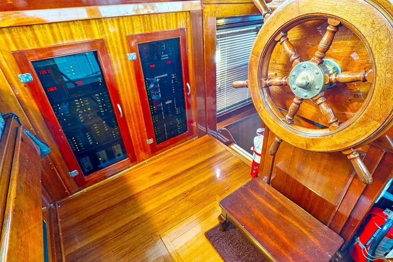 Slide: The Image of Interior of a 1926 Hacker-Craft Bridge Deck with wooden steering wheel. - 19