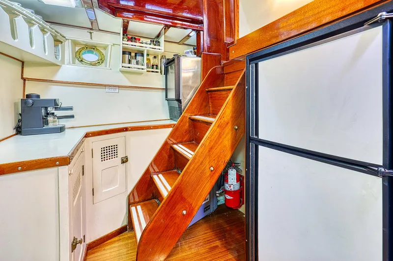 Slide: The Image of Interior of a 1926 Hacker-Craft Bridge Deck yacht with wooden staircase. - 22