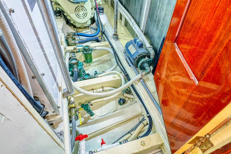 Slide: The Image of Engine room of a 1926 Hacker-Craft Bridge Deck boat, showing pipes and machinery. - 31