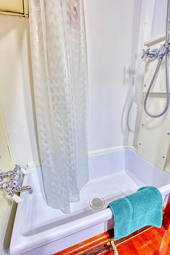 Slide: The Image of White bathtub with shower curtain and turquoise towel, 1926 Hacker-Craft boat. - 36