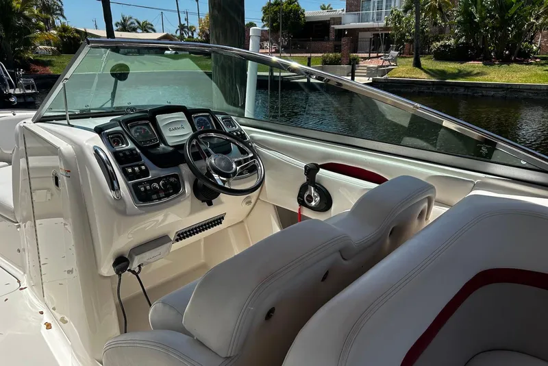 Slide: The Image of 2015 Chaparral 287 SSX boat cockpit with steering wheel and control panel. - 10