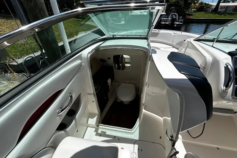 Slide: The Image of 2015 Chaparral 287 SSX boat interior with open cabin door and visible toilet. - 18
