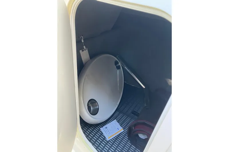 Slide: The Image of Storage compartment in 2015 Chaparral 287 SSX boat, featuring a round table and accessories. - 20