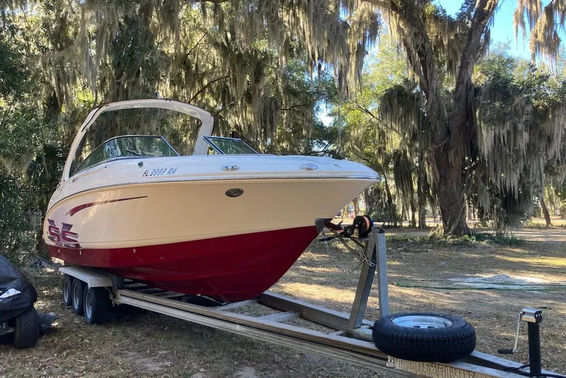 Slide: The Image of 2015 Chaparral 287 SSX boat on trailer, parked under trees with Spanish moss. - 4
