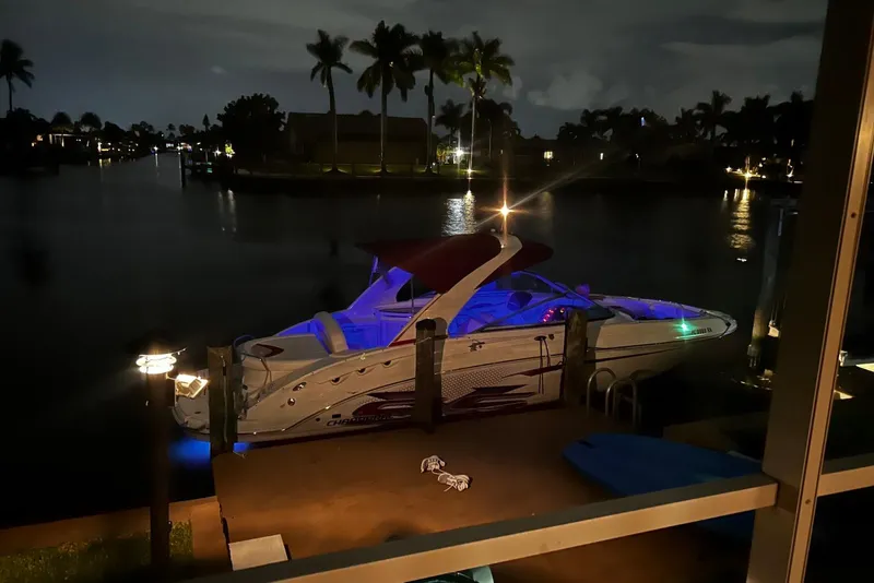 Slide: The Image of 2015 Chaparral 287 SSX boat docked at night, illuminated with blue lights. - 7