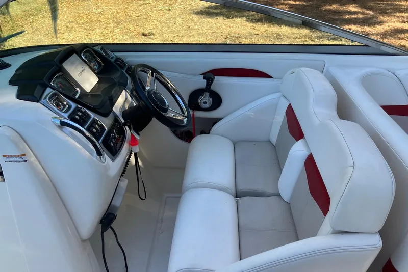 Slide: The Image of Interior of 2015 Chaparral 287 SSX boat with white and red seating, modern dashboard. - 8