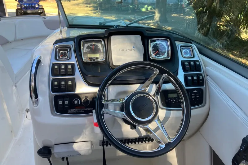 Slide: The Image of 2015 Chaparral 287 SSX boat dashboard with Garmin navigation system and steering wheel. - 9