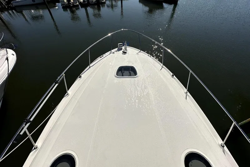 Slide: The Image of Bow view of 2003 Sea Ray 340 Sundancer yacht on calm water. - 12