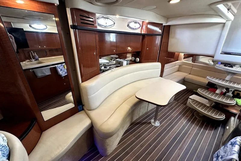 Slide: The Image of Luxurious interior of 2003 Sea Ray 340 Sundancer yacht with elegant seating and wooden finishes. - 16