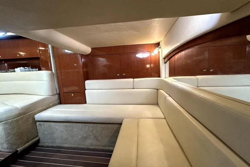 Slide: The Image of Luxurious interior of 2003 Sea Ray 340 Sundancer with cream seating and wooden cabinetry. - 20