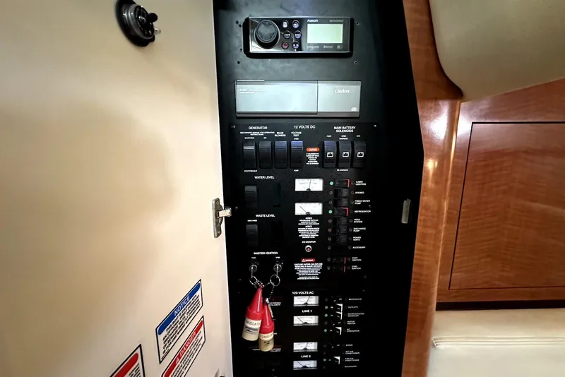 Slide: The Image of Electrical control panel of a 2003 Sea Ray 340 Sundancer boat interior. - 21