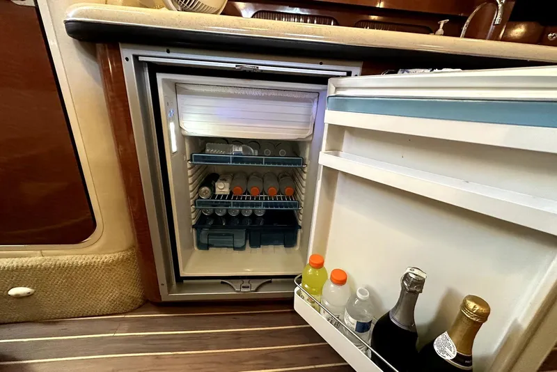 Slide: The Image of Mini fridge stocked with beverages inside a 2003 Sea Ray 340 Sundancer yacht. - 22