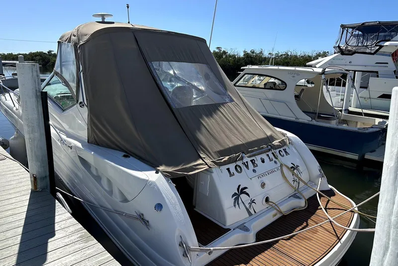 Slide: The Image of 2003 Sea Ray 340 Sundancer docked, featuring a covered cockpit and "Love Luck" name. - 6