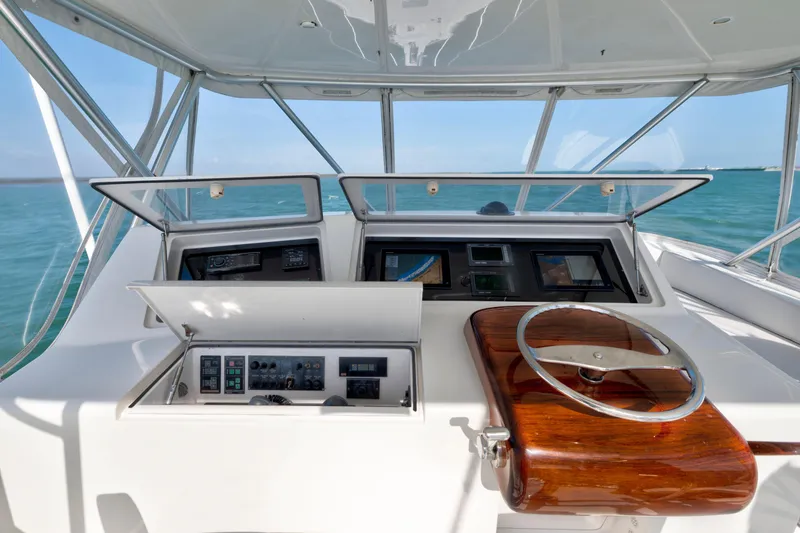 Slide: The Image of 2008 Viking Convertible yacht helm with wooden steering wheel and navigation controls. - 10