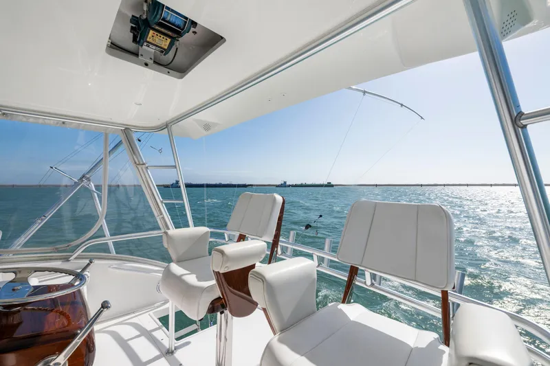 Slide: The Image of 2008 Viking Convertible yacht interior with ocean view and white seating. - 12