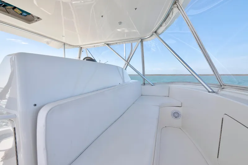 Slide: The Image of 2008 Viking Convertible boat interior with white seating and ocean view. - 16