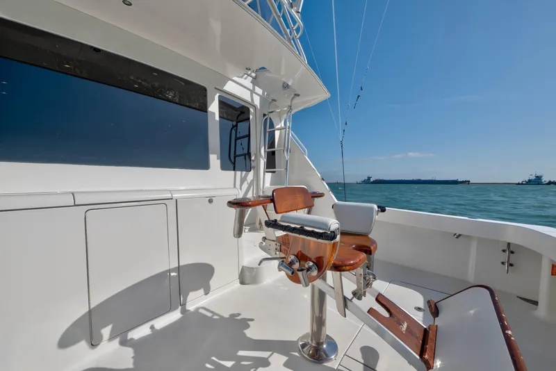 Slide: The Image of 2008 Viking Convertible yacht deck with fishing chair, ocean view, and clear blue sky. - 17
