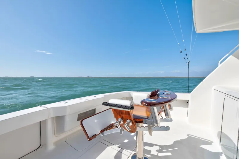 Slide: The Image of 2008 Viking Convertible yacht deck with fishing chair, overlooking the ocean under clear blue skies. - 19