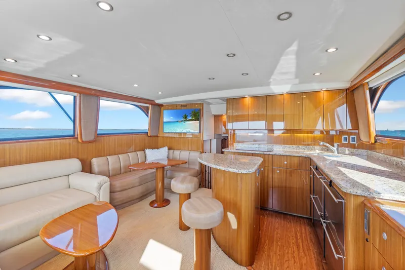 Slide: The Image of Luxurious interior of a 2008 Viking Convertible yacht with modern kitchen and seating area. - 22