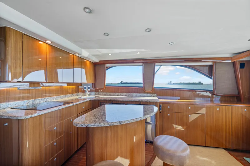 Slide: The Image of Luxurious 2008 Viking Convertible yacht interior with elegant wood cabinetry and ocean view. - 25