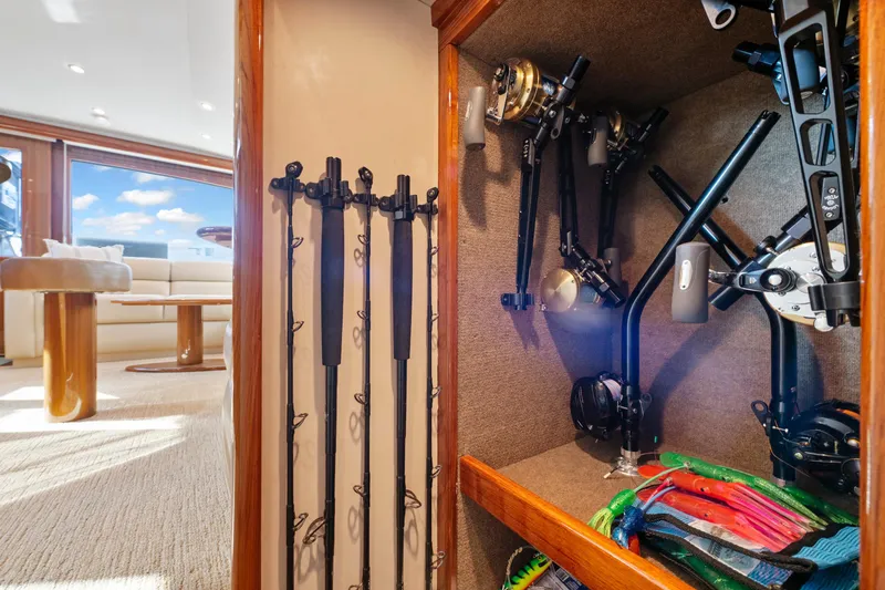 Slide: The Image of Fishing gear storage on 2008 Viking Convertible yacht, featuring rods and reels in a cozy cabin. - 27