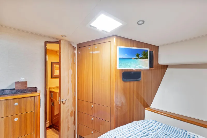 Slide: The Image of Luxurious 2008 Viking Convertible yacht interior with wood cabinetry and mounted TV. - 29