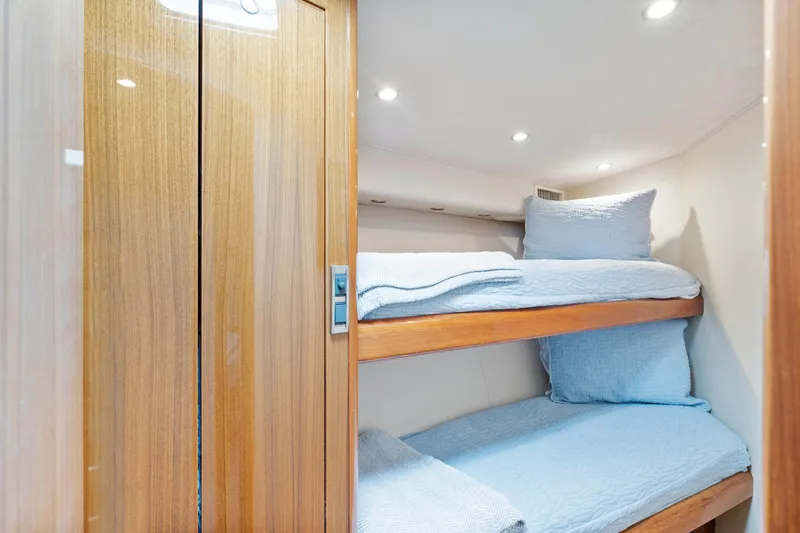 Slide: The Image of 2008 Viking Convertible yacht interior with cozy bunk beds and wooden finishes. - 31