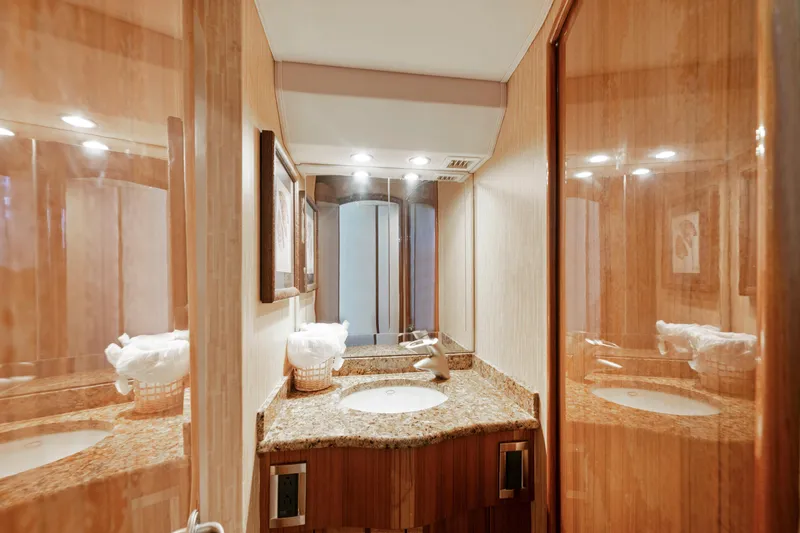 Slide: The Image of Luxurious bathroom in 2008 Viking Convertible yacht with granite countertop and elegant wood finish. - 32