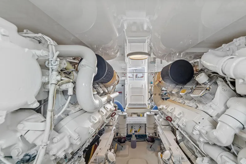 Slide: The Image of Engine room of a 2008 Viking Convertible yacht, showcasing dual engines and mechanical components. - 34