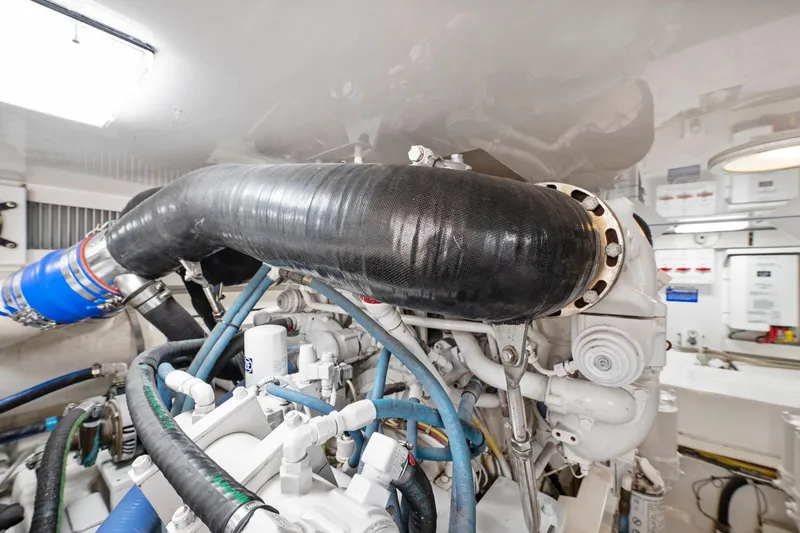 Slide: The Image of Engine room of a 2008 Viking Convertible yacht, showcasing complex machinery and piping. - 36