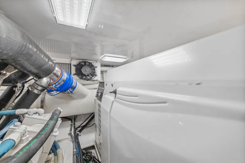 Slide: The Image of Engine room of a 2008 Viking Convertible yacht with visible pipes and machinery. - 38