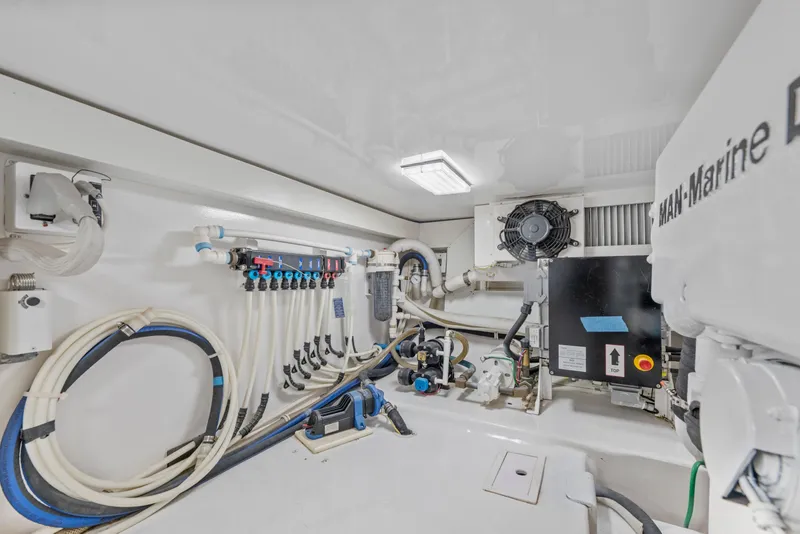 Slide: The Image of Engine room of a 2008 Viking Convertible yacht with marine equipment and piping. - 41