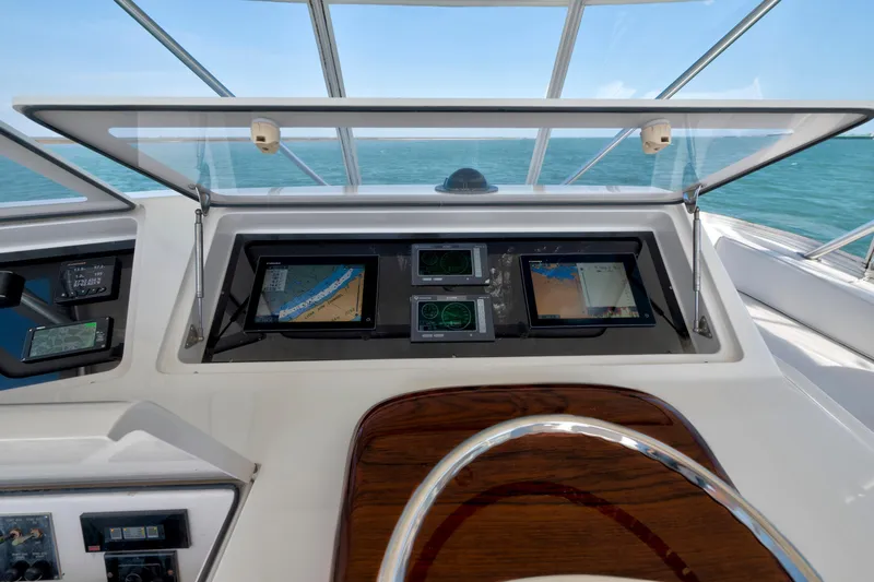 Slide: The Image of 2008 Viking Convertible yacht helm with navigation screens and ocean view. - 9