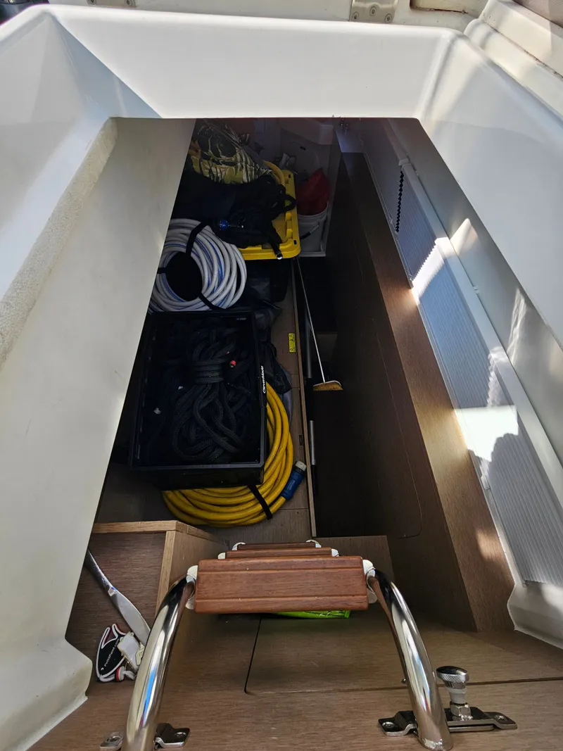 Slide: The Image of Storage compartment in Prestige 460 boat, filled with ropes and equipment. - 13